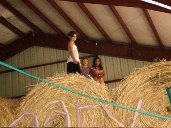 Kids sitting on haystack