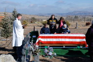 Father Theron and family with casket